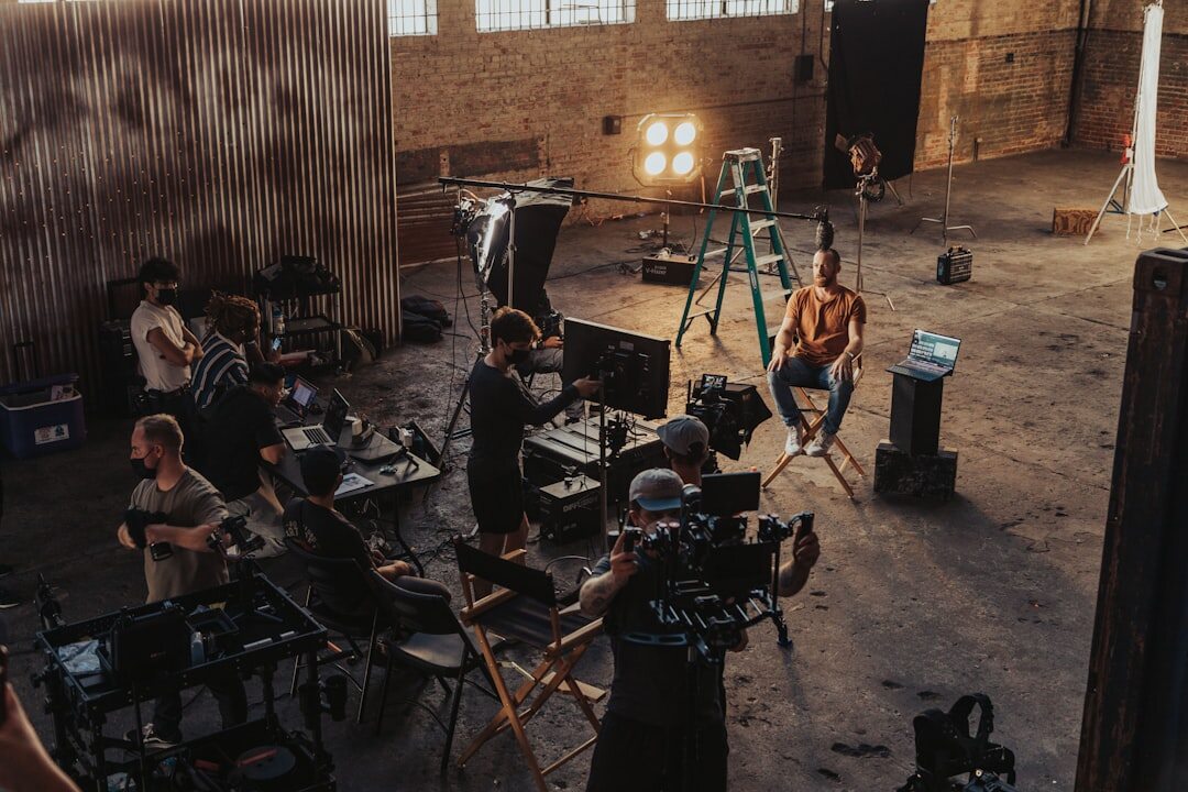 Video production team working with camera equipment on set