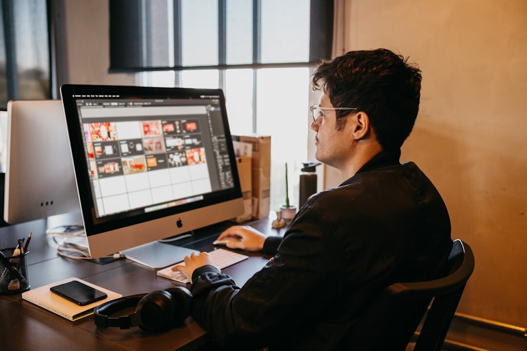Digital media professional working on a computer with analytics dashboards