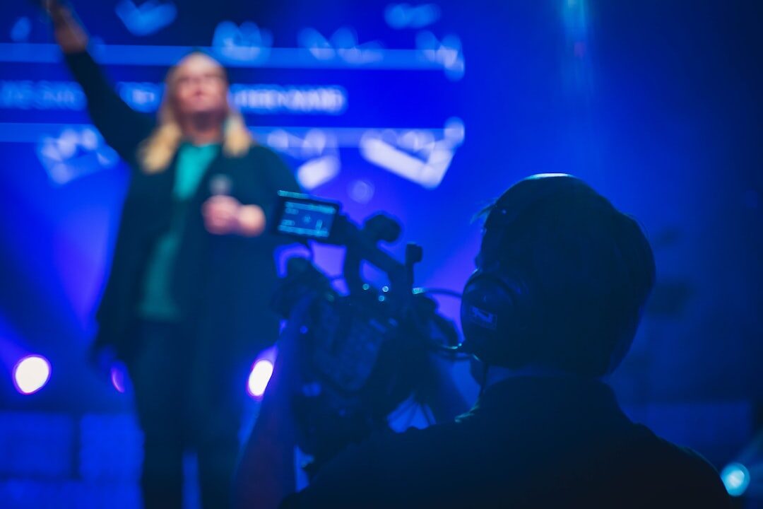 Professional TV presenter speaking in front of a camera